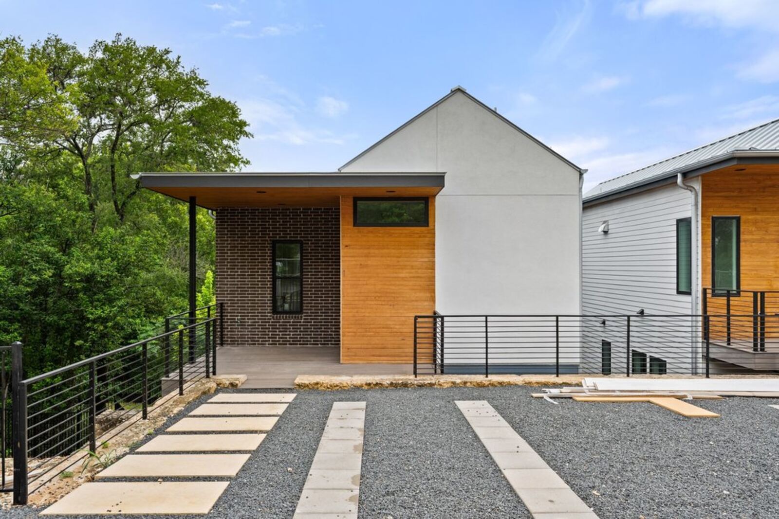 Front elevation with wood accent and paver walkway