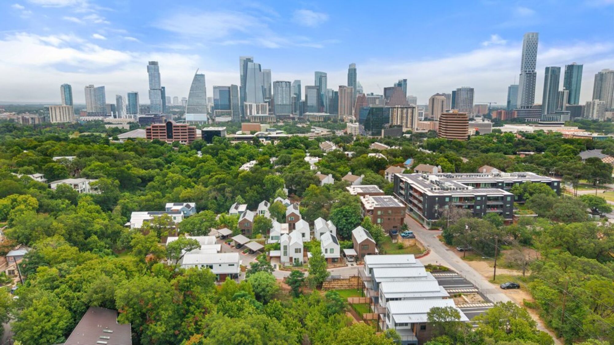 Aerial view of Frank West townhomes in Bouldin Creek with the downtown Austin skyline beyond